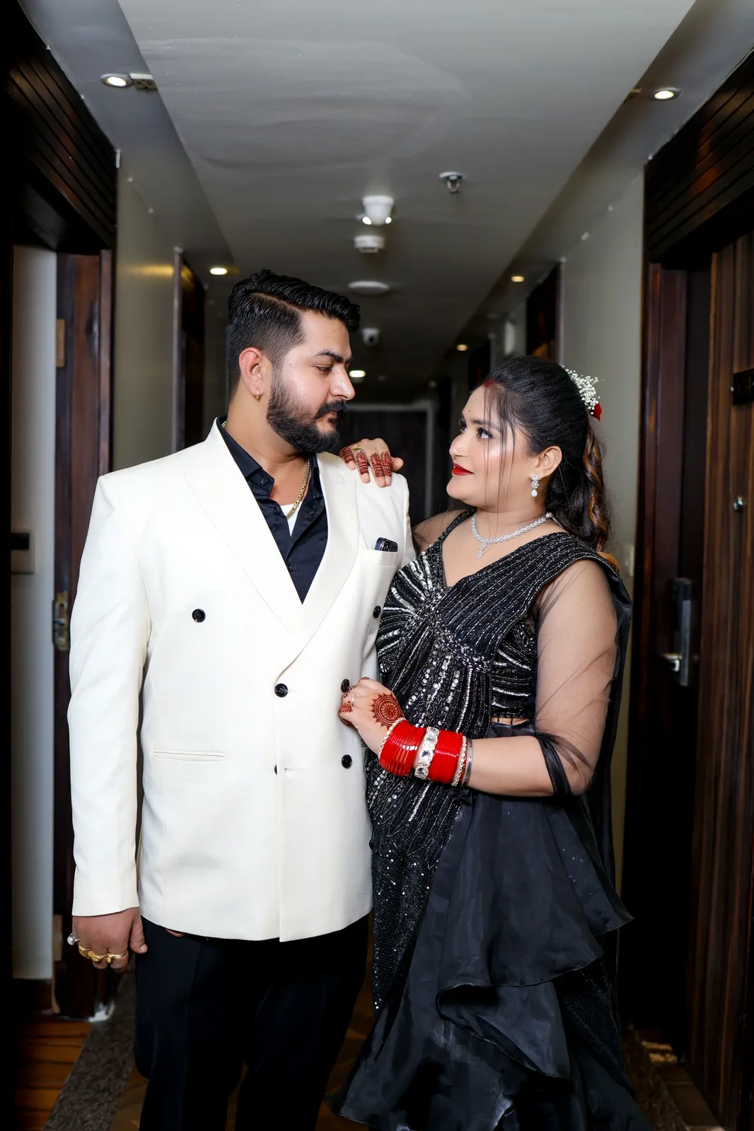 Reception couple portrait — ivory blazer & black saree